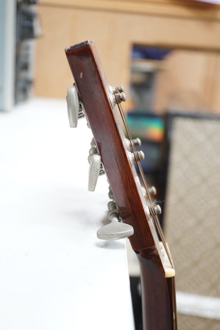 A Yamaha FG-180 acoustic steel string guitar